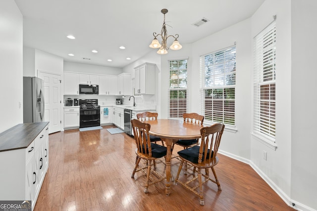 449 Highlands Loop, Woodstock, GA 30188 - dining area featuring hardwood / wood-style flooring, a chandelier, baseboards, and recessed lighting