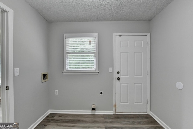 clothes washing area with laundry area, a textured ceiling, washer hookup, and dark wood-style flooring
