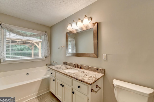 full bath featuring a garden tub, a textured ceiling, tile patterned flooring, vanity, and toilet
