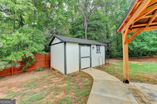 view of shed featuring fence