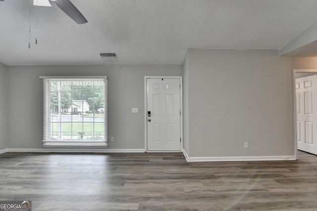 unfurnished living room featuring baseboards, a ceiling fan, and wood finished floors