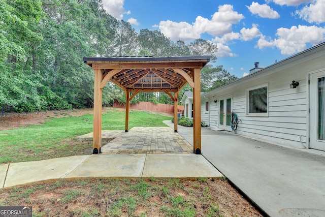 view of patio with a gazebo, fence, and french doors