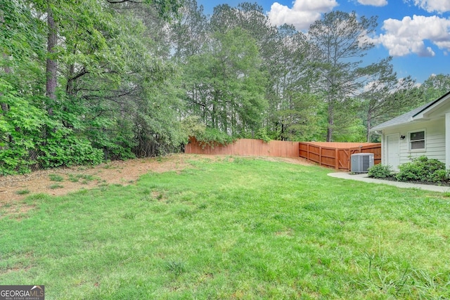 view of yard featuring a fenced backyard and central AC unit