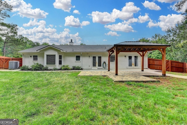rear view of property with fence, a patio, french doors, a lawn, and central air condition unit