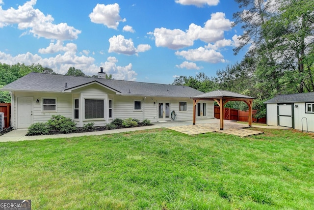 rear view of house with a gazebo, a shed, french doors, a patio, and a yard
