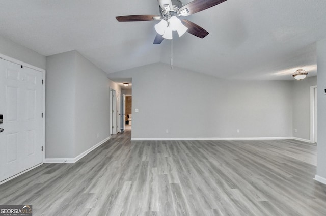 unfurnished living room featuring light wood-style floors, baseboards, ceiling fan, and lofted ceiling