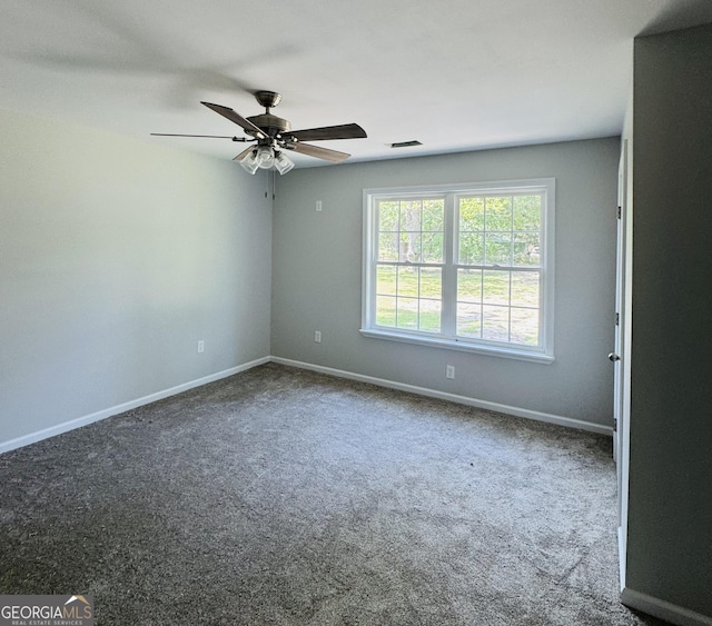 carpeted empty room featuring baseboards, a ceiling fan, and visible vents