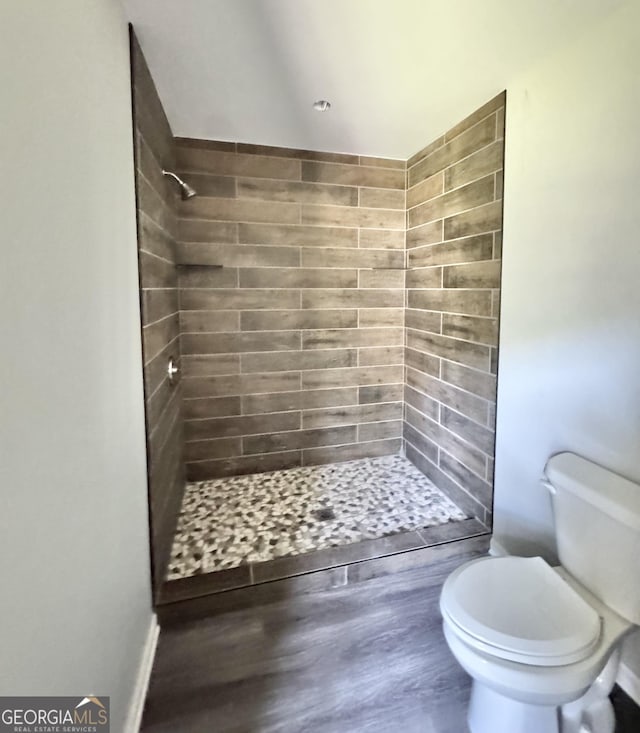 full bathroom with toilet and a shower stall