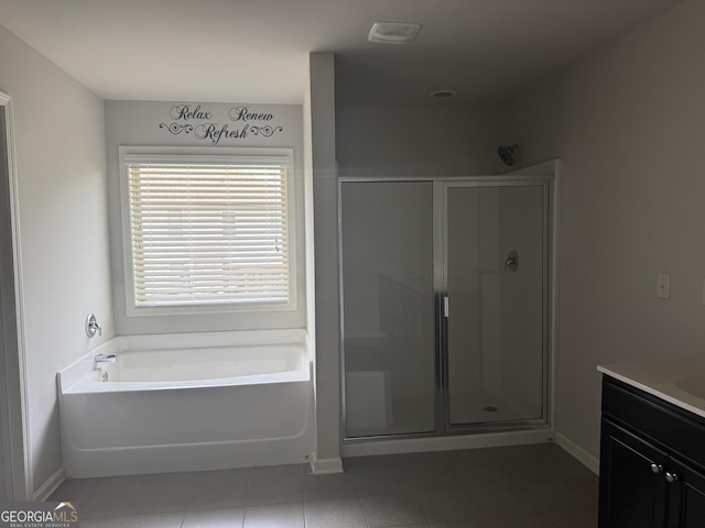 full bathroom featuring vanity, baseboards, a garden tub, and a stall shower