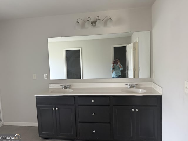 1124 Pebble Creek Ln, Locust Grove, GA 30248 - full bath with tile patterned floors, double vanity, baseboards, and a sink