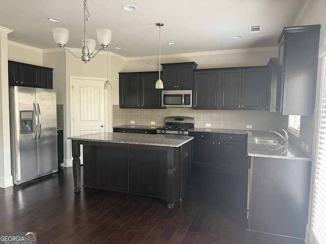 kitchen featuring visible vents, a sink, light stone counters, and stainless steel appliances