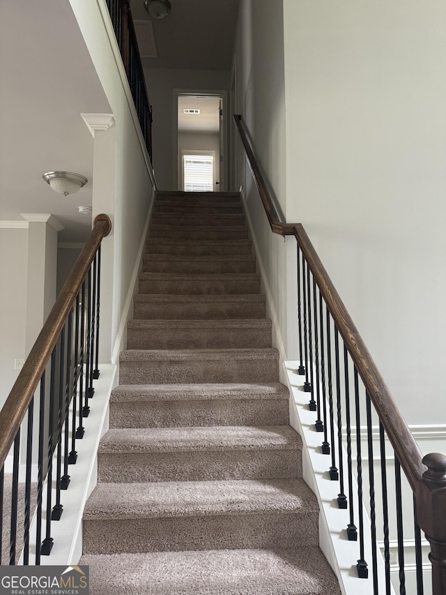 staircase with crown molding