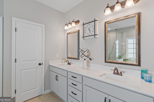 bathroom featuring double vanity, a sink, walk in shower, and tile patterned flooring