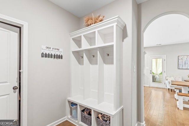 mudroom with baseboards and wood finished floors