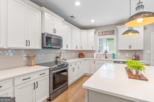 kitchen with a sink, appliances with stainless steel finishes, and light countertops