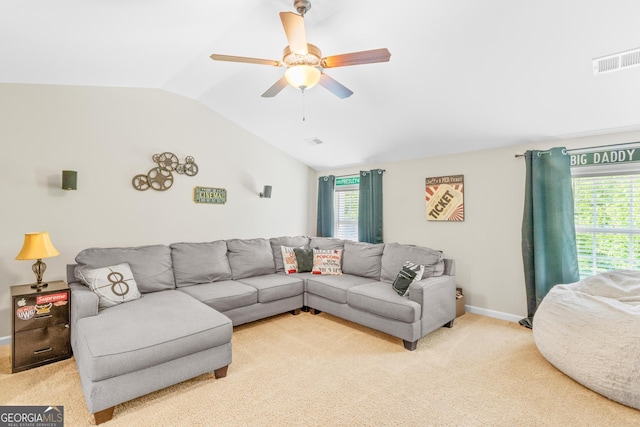 living room with visible vents, ceiling fan, vaulted ceiling, and a healthy amount of sunlight