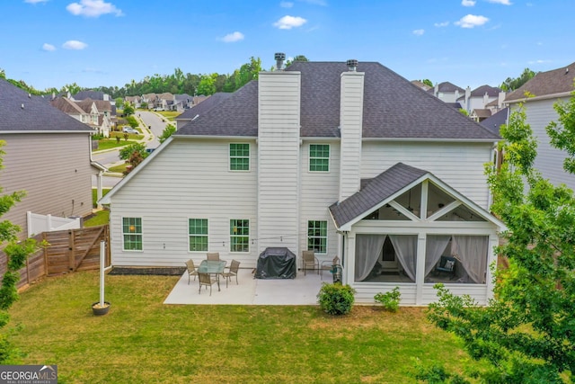 back of house featuring a residential view, fence, a chimney, and a patio area