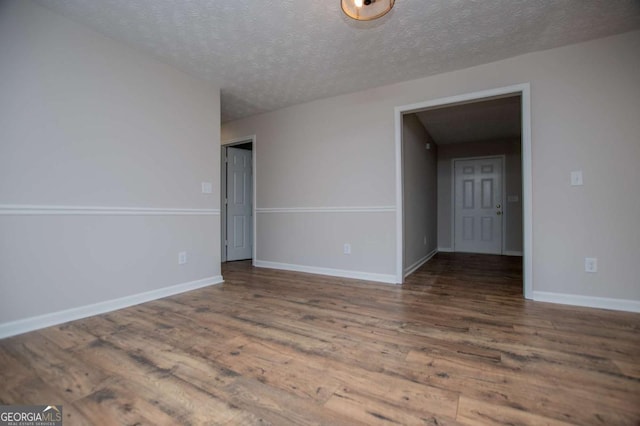 6213 Cherry Ln, Douglasville, GA 30134 - empty room with wood finished floors, a textured ceiling, and baseboards