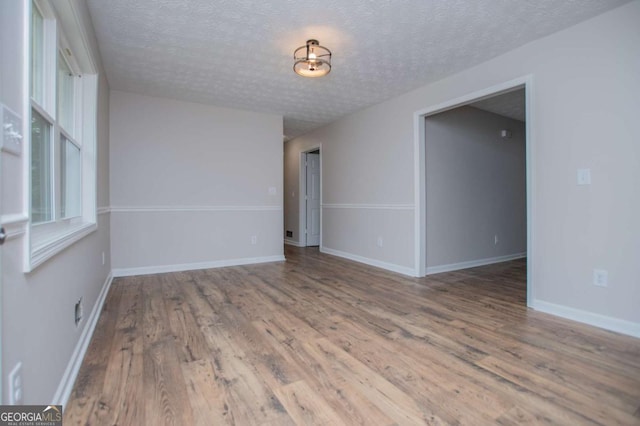 6213 Cherry Ln, Douglasville, GA 30134 - unfurnished room with wood finished floors, a textured ceiling, and baseboards