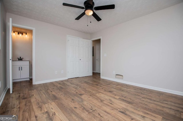 6213 Cherry Ln, Douglasville, GA 30134 - unfurnished bedroom featuring wood finished floors, baseboards, and a textured ceiling