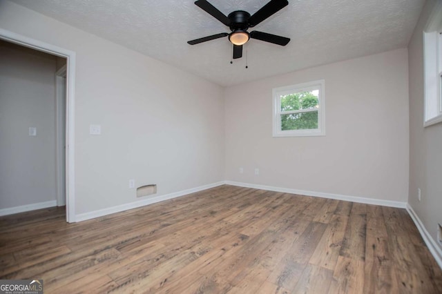 6213 Cherry Ln, Douglasville, GA 30134 - unfurnished room with wood finished floors, a textured ceiling, baseboards, and a ceiling fan