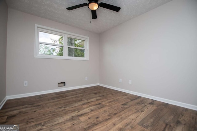 6213 Cherry Ln, Douglasville, GA 30134 - unfurnished room featuring a textured ceiling, dark wood-style flooring, baseboards, and a ceiling fan