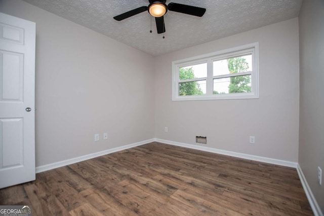 6213 Cherry Ln, Douglasville, GA 30134 - spare room with a textured ceiling, dark wood-style flooring, baseboards, and a ceiling fan