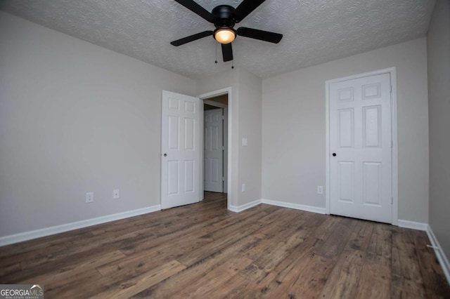 6213 Cherry Ln, Douglasville, GA 30134 - unfurnished bedroom with dark wood-style floors, a textured ceiling, baseboards, and a ceiling fan