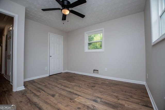 6213 Cherry Ln, Douglasville, GA 30134 - unfurnished bedroom featuring a textured ceiling, wood finished floors, baseboards, and a ceiling fan