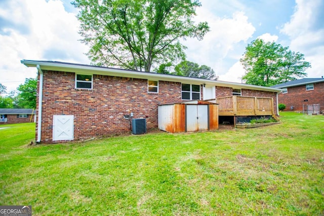 6213 Cherry Ln, Douglasville, GA 30134 - rear view of house with a storage shed, a wooden deck, brick siding, and a yard