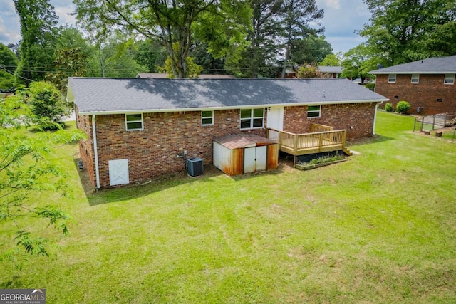 6213 Cherry Ln, Douglasville, GA 30134 - back of house featuring a storage shed, a deck, a lawn, and brick siding