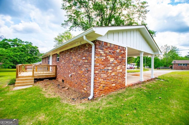 6213 Cherry Ln, Douglasville, GA 30134 - view of home's exterior with brick siding, a yard, board and batten siding, concrete driveway, and a wooden deck