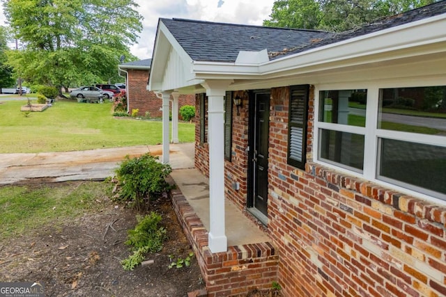 6213 Cherry Ln, Douglasville, GA 30134 - view of property exterior featuring brick siding, a shingled roof, a lawn, and a porch