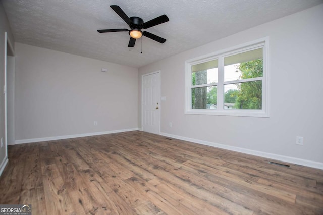 6213 Cherry Ln, Douglasville, GA 30134 - empty room featuring wood finished floors, a textured ceiling, baseboards, and a ceiling fan