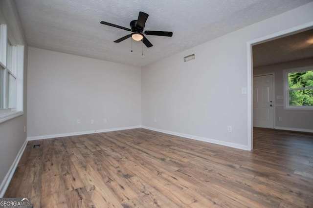 6213 Cherry Ln, Douglasville, GA 30134 - empty room featuring wood finished floors, a textured ceiling, a ceiling fan, and baseboards
