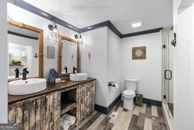 1601 Arrowhead Rd, Greensboro, GA 30642 - full bathroom featuring double vanity, toilet, a sink, and a stall shower