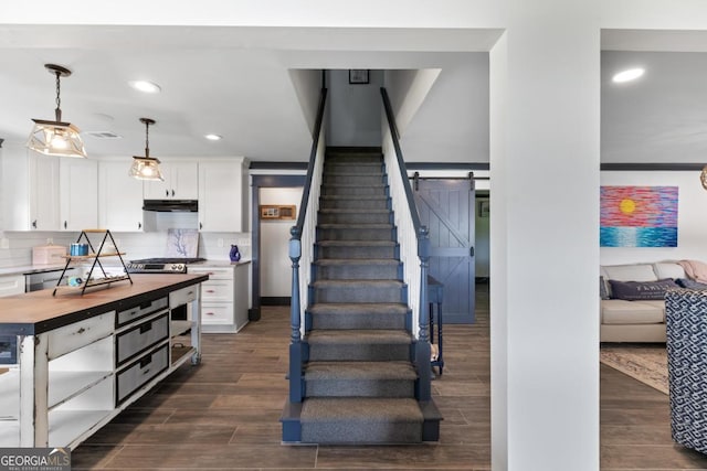 1601 Arrowhead Rd, Greensboro, GA 30642 - stairs featuring recessed lighting, visible vents, a barn door, and wood finished floors