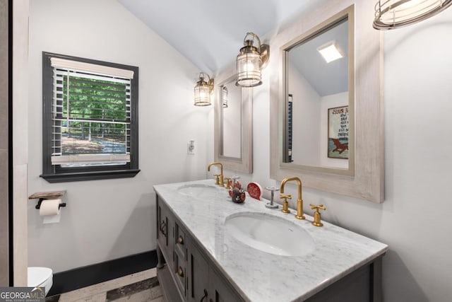 1601 Arrowhead Rd, Greensboro, GA 30642 - bathroom with double vanity, toilet, vaulted ceiling, and a sink