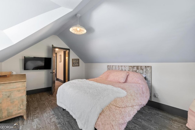 1601 Arrowhead Rd, Greensboro, GA 30642 - bedroom with baseboards, wood finished floors, and vaulted ceiling with skylight