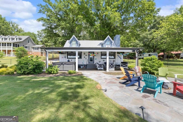 1601 Arrowhead Rd, Greensboro, GA 30642 - back of property featuring a chimney, a patio area, a hot tub, fence, and a yard