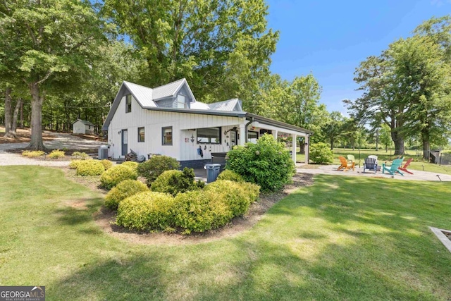 1601 Arrowhead Rd, Greensboro, GA 30642 - back of property with a lawn, an outdoor fire pit, a patio area, and central AC