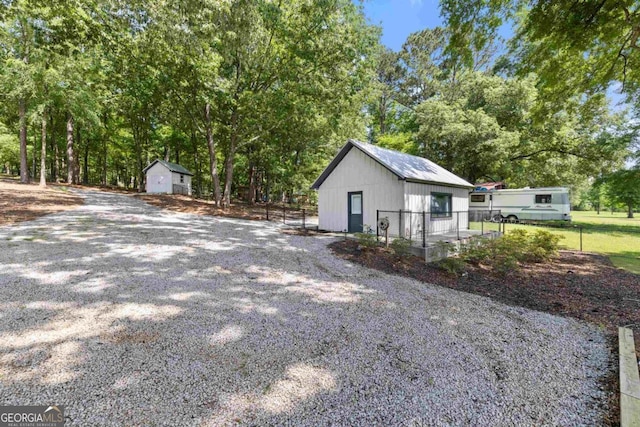 1601 Arrowhead Rd, Greensboro, GA 30642 - view of property exterior with fence, a storage unit, and an outdoor structure