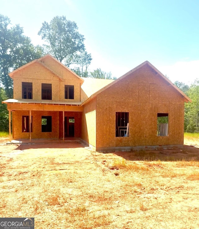 rear view of property featuring a porch