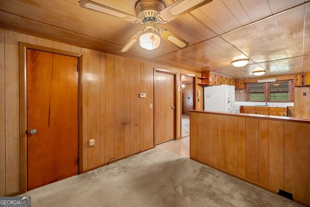 3011 Refuge Rd, Jasper, GA 30143 - kitchen with white refrigerator with ice dispenser, light carpet, and wood walls