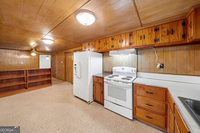 3011 Refuge Rd, Jasper, GA 30143 - kitchen with under cabinet range hood, wooden ceiling, brown cabinets, and white appliances