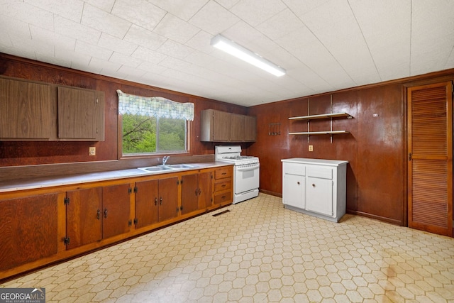 3011 Refuge Rd, Jasper, GA 30143 - kitchen featuring white gas stove, open shelves, wood walls, light countertops, and brown cabinets