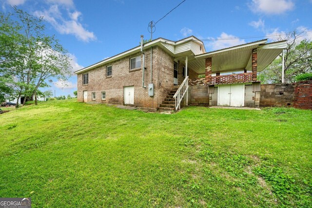 3011 Refuge Rd, Jasper, GA 30143 - back of house featuring a yard, stairway, and brick siding