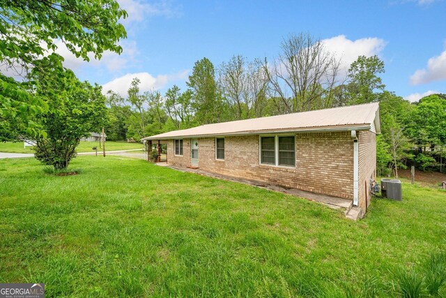 3011 Refuge Rd, Jasper, GA 30143 - exterior space featuring central AC, brick siding, and a lawn