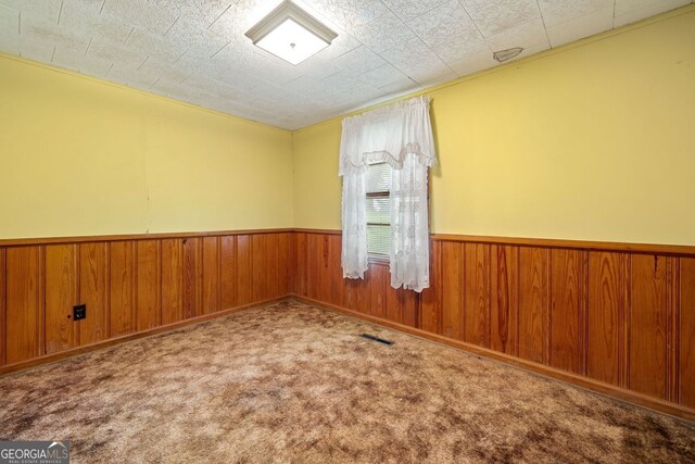 3011 Refuge Rd, Jasper, GA 30143 - spare room featuring wood walls, wainscoting, visible vents, and carpet
