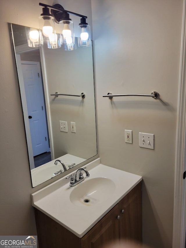 bathroom with vanity and a notable chandelier